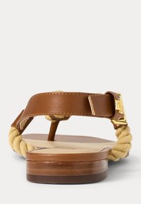 Brown leather and beige rope thong sandal with flat sole and gold buckle detail, front view on plain background.