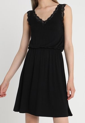 Black sleeveless dress with lace trim on the v-neckline, gathered waist, and flowy skirt. Made of soft, stretchy fabric.