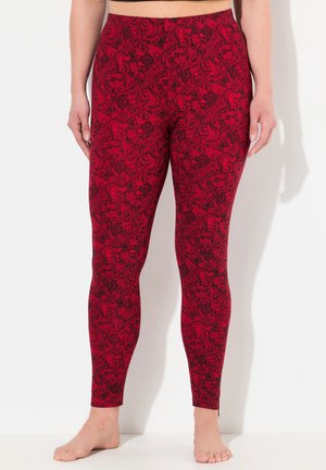 Rode leggings met een zwart bloemen- en paisleypatroon, met een aansluitend ontwerp en een elastische tailleband, gemaakt van rekbare stof.
