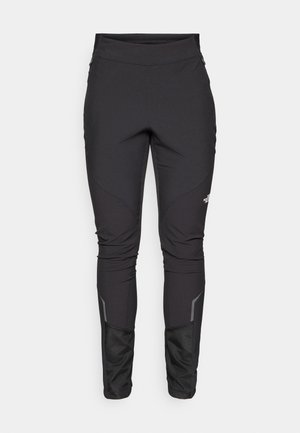 Pantalons d'extérieur noirs à coupe ajustée, en tissu durable, avec des accents réfléchissants et des coutures en panneaux pour une mobilité et un confort accrus.