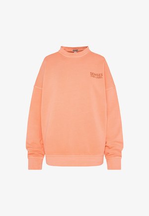 Oversized coral sweatshirt with a mock neck, dropped shoulders, ribbed cuffs, and a small logo on the chest in a contrasting shade.