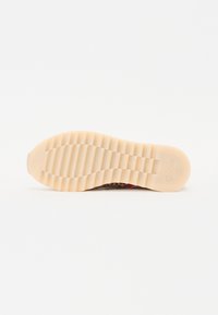 Suola della scarpa con una superficie texture, di colore beige e scanalature a motivo per una migliore aderenza. Nome del marchio "Gabor" impresso di lato.