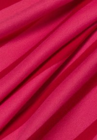 Fuchsia fabric with a ribbed texture, featuring alternating smooth and textured stripes, showcasing vibrant color and soft drape.