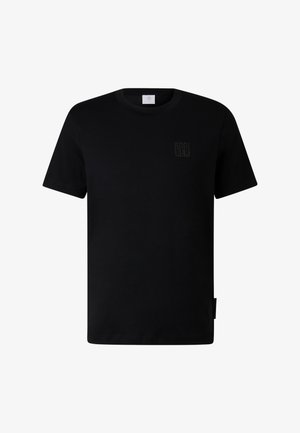 T-shirt en coton noir avec col rond, manches courtes et un logo noir discret sur la poitrine. Il présente un ourlet droit avec une étiquette latérale.