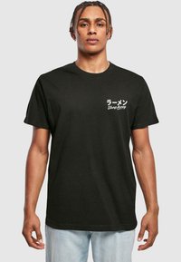 Black cotton t-shirt featuring white text in Japanese and "Slurp Away" on the front. Classic crew neck and short sleeves, ample fit.