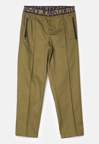Olive green pants with black zippered side pockets and a navy waistband featuring "VERSACE JEANS COUTURE" text.