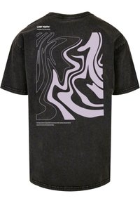 Černé bavlněné tričko s velkým abstraktním designem v světle fialové na zadní straně. Text zní: "Ztracená mladost: Najdi krásu v chaosu."