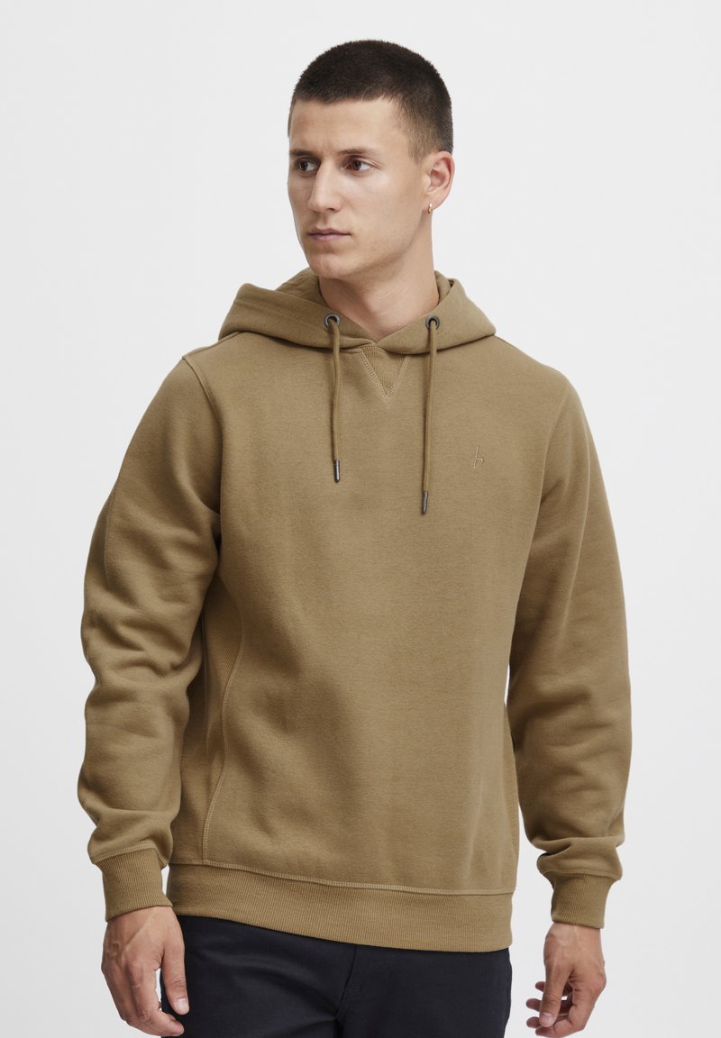 Brown hoodie made of soft fabric, featuring a drawstring hood, ribbed cuffs and hem, and a small logo on the chest.
