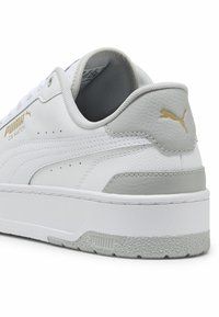 Puma CA Match sneakers med en hvid læderoverdel, grå detaljer, tekstureret gummisål og guldbranding p�å siden.