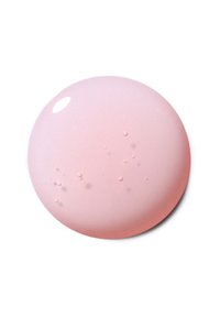 Goccia di liquido rosa chiaro lucido con piccole bolle su uno sfondo bianco.
