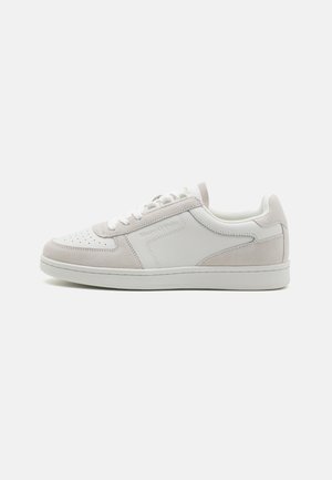 White sneaker with light gray suede accents, perforated toe, flat laces, and a smooth, cushioned sole. Minimalistic design with branding.