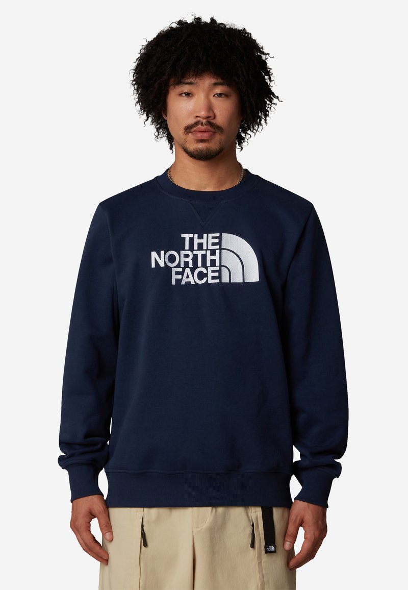 Felpa blu navy, in misto cotone, con collo a giro, polsini e orlo a costine, caratterizzata da un logo bianco prominente sulla parte frontale.