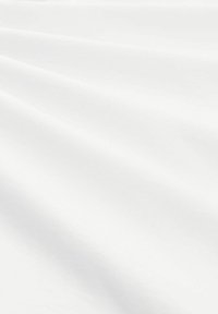 White fabric with a smooth, soft texture, showing subtle folds and shadows. The surface is uniform, without any patterns or accents.