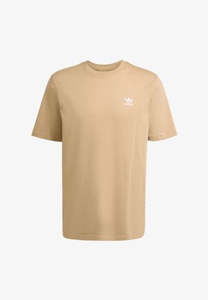 Beige cotton t-shirt with short sleeves, round neck, and a white Adidas logo on the upper left chest. Simple, plain design with no patterns.