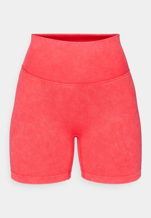 Lyse rosa treningsshorts med høy midje, laget av et glatt, elastisk materiale. Har ensfarget design og sømløs konstruksjon uten dekorasjoner.