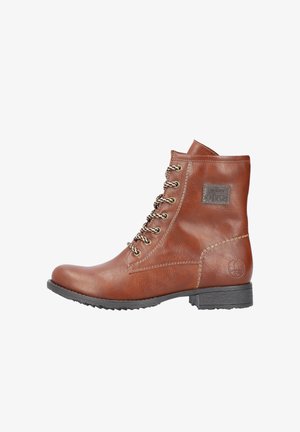 Brown leather ankle boot featuring metal eyelets, lace-up front, stitched accents, and a textured surface with a logo patch on the side.
