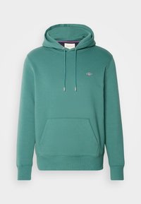 Sweat à capuche vert sarcelle avec poche avant, cordons de serrage, poignets et ourlet côtelés, et petit logo brodé sur la poitrine.