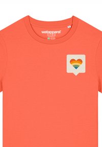 Koraalkleurig T-shirt gemaakt van een katoenmix met een ronde halslijn. Heeft een hartgraphic in een spraakbel, met warme regenboogkleuren.