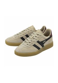 Beige suede sneakers with black stripes, rubber gum sole, and maroon accents on the heel. Features lace-up design and padded collar.
