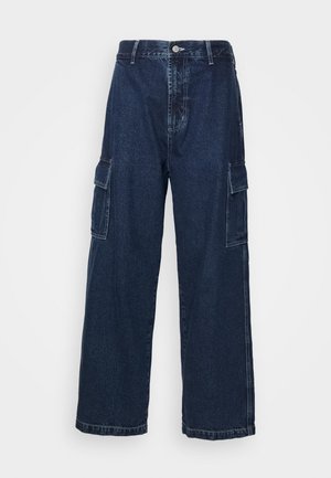 Dark blue denim cargo pants with a straight leg, two side pockets, and a button closure at the waist. Durable fabric with a smooth texture.