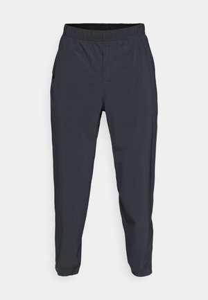 Sötétszürke, könnyű anyagból készült sportnadrág, elasztikus derékpánttal és két oldalzsebbel. Vékonyodó szárú kialakítás.