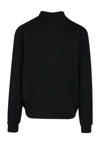 Mustaline sweatshirt kõrge kaelus, pikad varrukad ja soonikkoes mansetid. Pehme kangas sileda tekstuuriga ning ilma nähtavate mustrite või logodeta.
