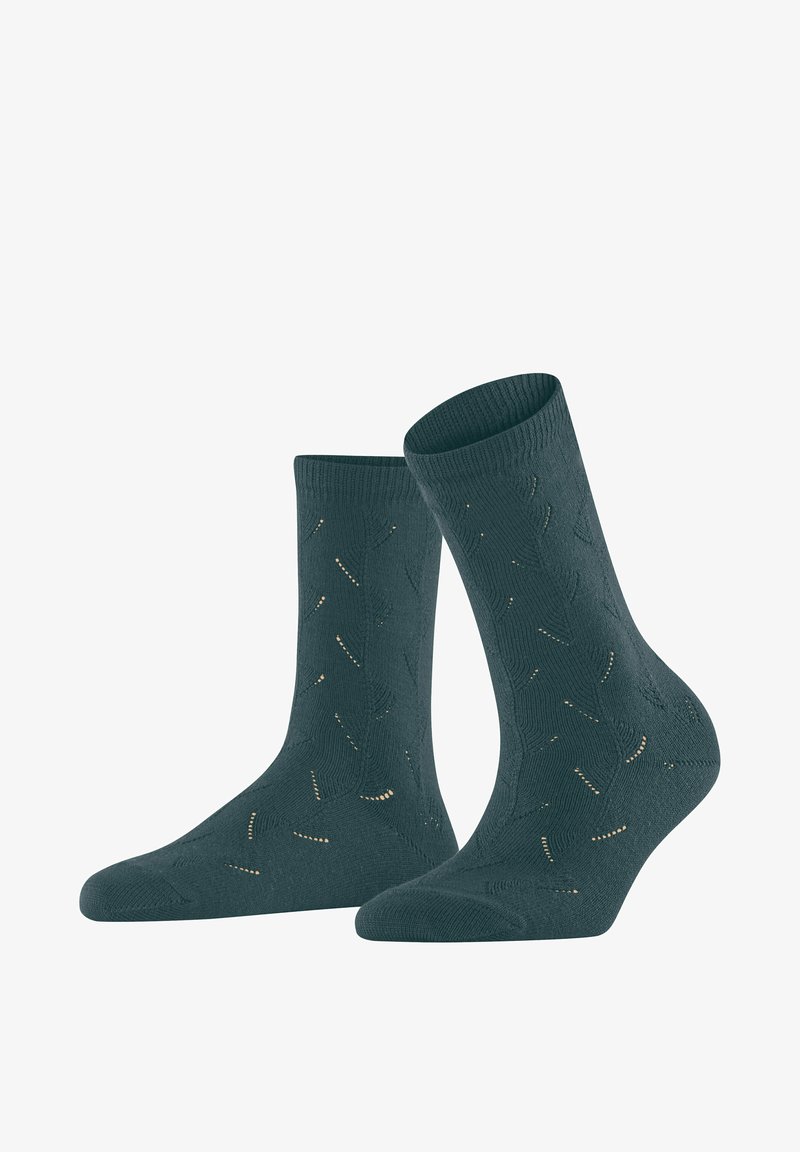 Türkisfarbene, gestrickte Socken mit gerippten Bündchen und einem durchgehenden Muster aus kleinen Aussparungen und goldenen Akzenten. Weiche Textur, geeignet für den Freizeitgebrauch.