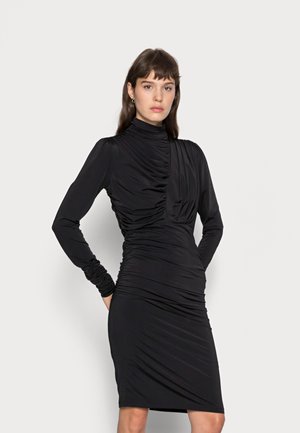 Black long-sleeve dress with a high neckline, featuring gathered details and a fitted silhouette. Made of smooth, stretchy fabric.