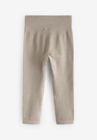 Leggings beige a costine con una larga vita elastica, gambe dritte e una finitura morbida e testurizzata. Senza loghi o motivi visibili.