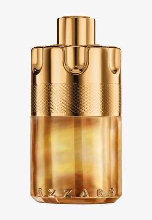 Bottiglia di profumo in vetro oro e ambra con tappo dorato testurizzato. Presenta una fascia decorata e il nome del marchio inciso alla base.