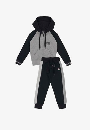 Survêtement enfant deux pièces gris et noir, sweat à capuche zippé, pantalon à cordon, et logo Leone 1947 sur la poitrine et le pantalon.