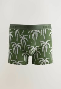 Zelene bokserice s uzorkom palm tree u bijeloj boji. Elastična traka također je zelena i ima urezanu marku "NEXT".