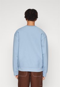Carhartt WIP AMERICAN SCRIPT - Mikina - frosted blue