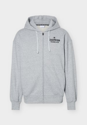 Felpa con cappuccio grigia chiaro con zip, tasche frontali, coulisse e logo con la scritta "Champion Training Club" sul petto a sinistra.