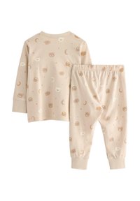 Pyjamakitt med långärmad topp och byxor med elastisk midja i mjuk beige bomull. Mönster av björnar och månar i dämpade färger.
