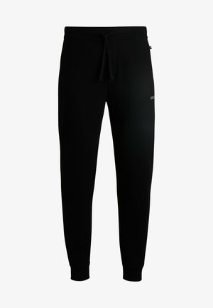 Pantalon de survêtement noir avec une taille élastique et un cordon de serrage, fabriqué dans un tissu texturé et avec des poignets ajustés aux chevilles. Logo sur le côté.