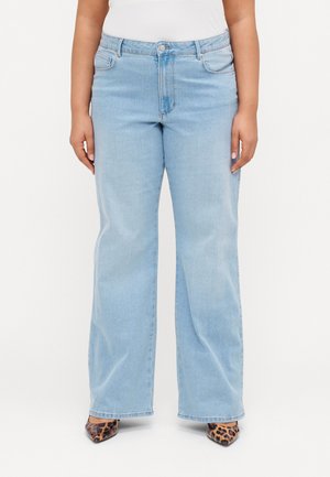 Light blue straight-leg jeans made of denim, featuring front pockets, a button closure, and subtle fading. Worn with pointed leopard print heels.