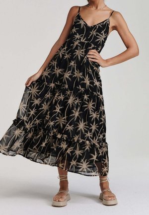 Robe maxi noire avec imprimé palmiers beige, dotée de fines bretelles et de volants en étages. Tissu léger avec une silhouette fluide.