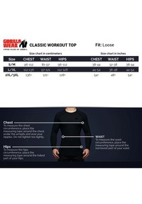 Zwarte langemmouwige trainingstop met een ronde hals, getailleerd ontwerp, schoudernaden en meetinstructies voor borst, taille en heupen.