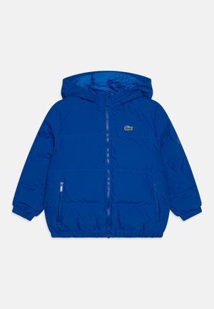 Blue puffer jacket with a hood, zip front, elastic cuffs, and side pockets. Features a small embroidered logo on the left chest.