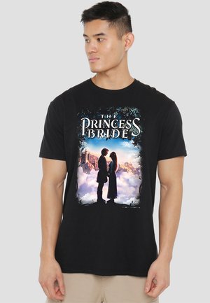 Black t-shirt featuring "The Princess Bride" graphic with silhouettes of a couple against a colorful cloud background and decorative border.