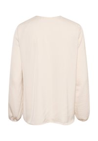 Cremefarbige Bluse mit langen Ärmeln und rundem Ausschnitt, strukturierter Stoff und gerafften Bündchen. Weiches, leichtes Material mit lässiger Passform.
