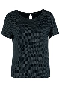 Kortärmad svart topp med vita prickar, rund halsringning och en liten nyckelhålsdetalj bak. Tillverkad av mjukt tyg.