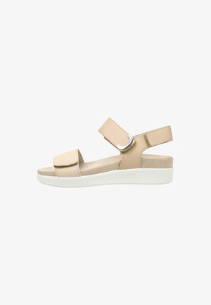 Sandalia beige con punta abierta con dos correas ajustables y una suela blanca acolchada.
