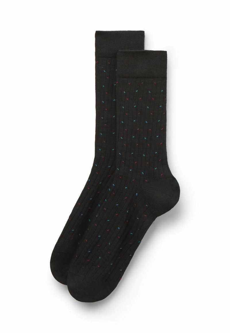 Svarta ribbade strumpor med ett färgglatt prickmönster i röd och blå. Har en längd till mitten av vaden och en slät textur.