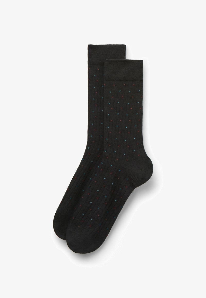 Calze nere a coste con motivo a pois colorati in rosso e blu. Presentano una lunghezza fino al polpaccio e una texture liscia.