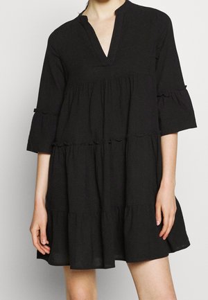 Černé bavlněné šaty s výstřihem do V, tříčtvrtečními zvonovými rukávy a volánovými doplňky. Vícevrstvý design a volný střih zvyšují pohodlí.