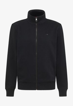 Veste zippée noire avec col montant, poignets et ourlet côtelés, en tissu doux arborant un logo discret sur la poitrine. Texture lisse.