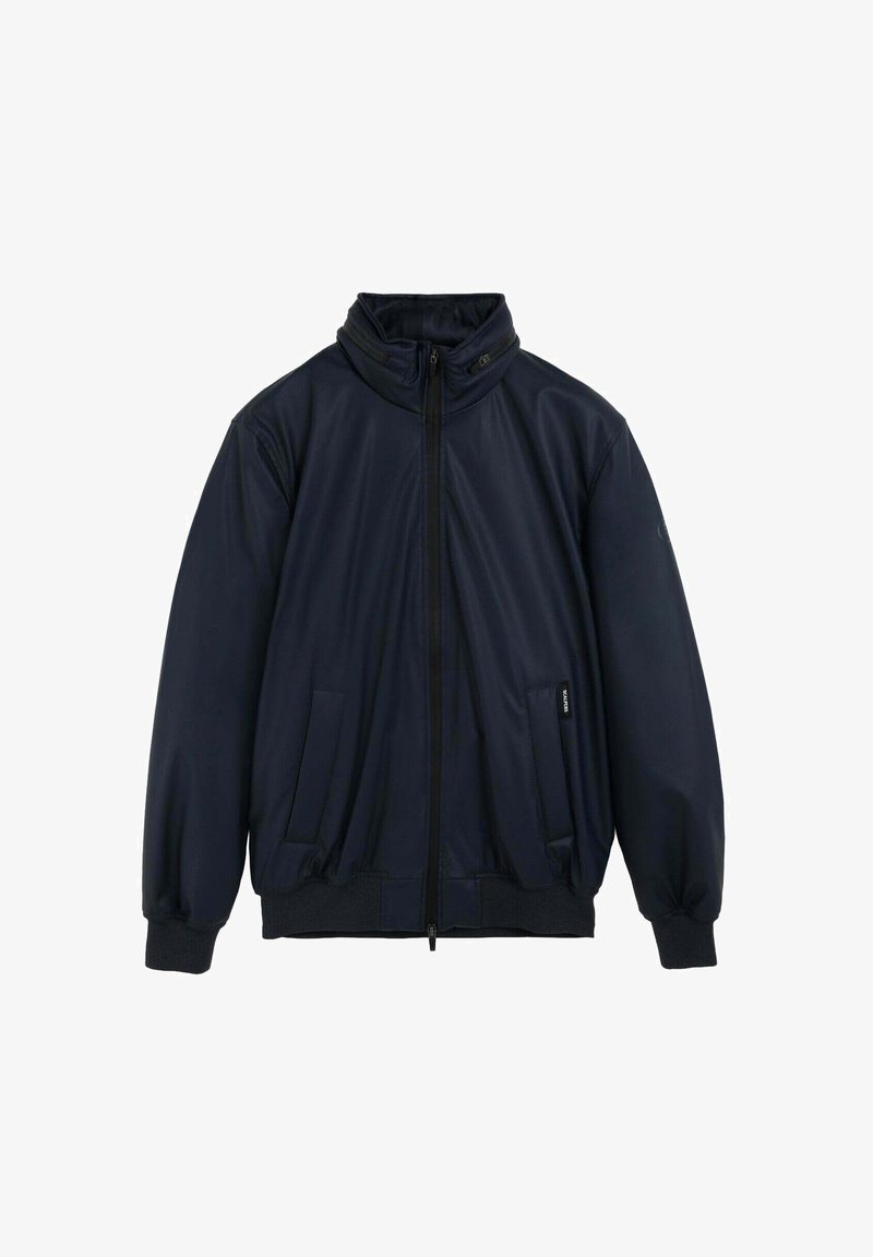 Veste zippée bleue marine avec col haut, deux poches latérales, poignets élastiques et ourlet côtelé.