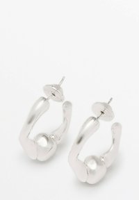 Silver-tone hoop earrings with a curved design and spherical accents. The surface is smooth and polished, featuring a stud post.